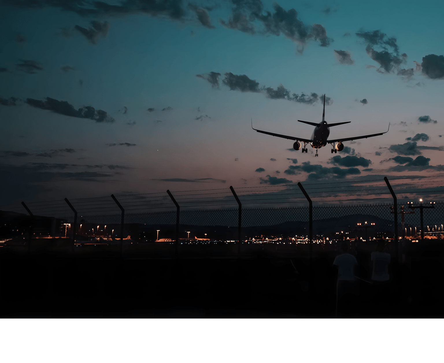 Passenger aircraft approaching a runway at dusk